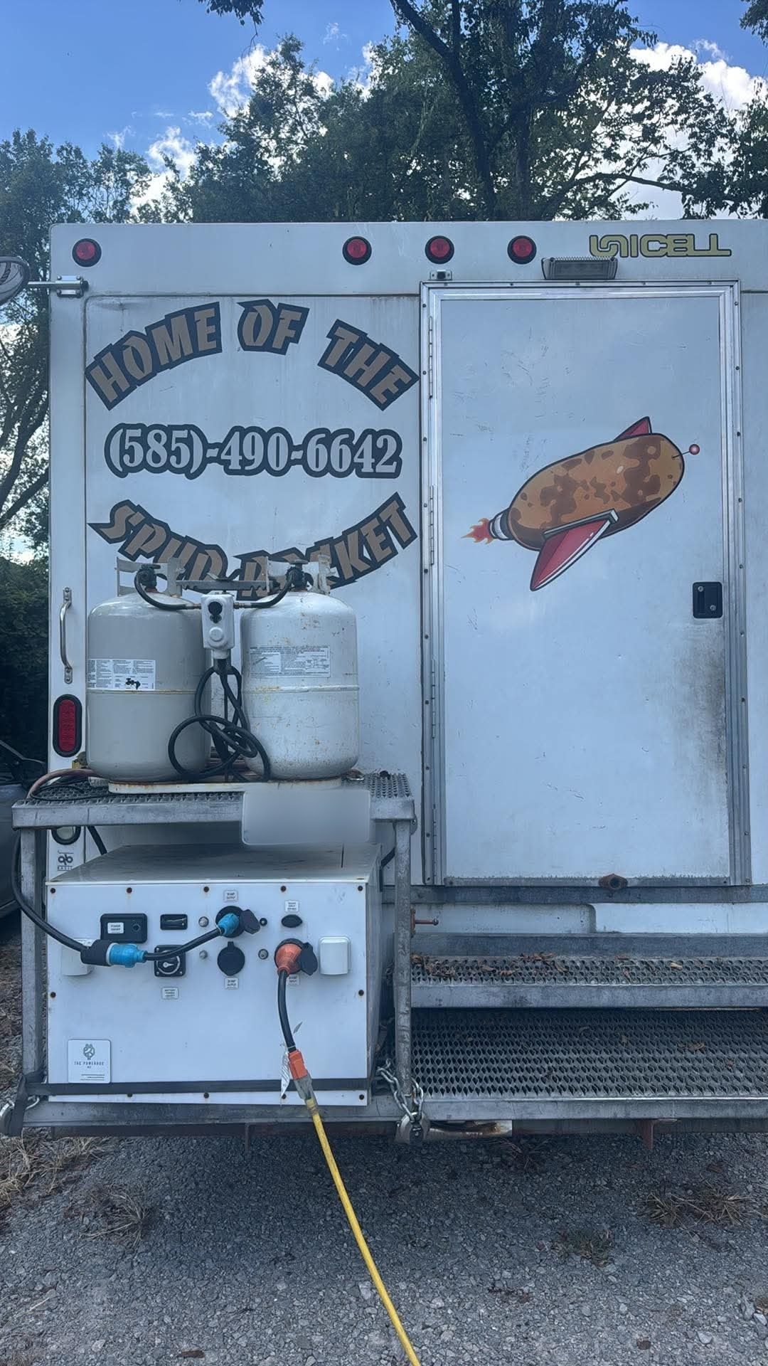 PowerBox 10K mounted on the rear bumper of the Spud Rocket food truck, plugged in and running beside propane tanks